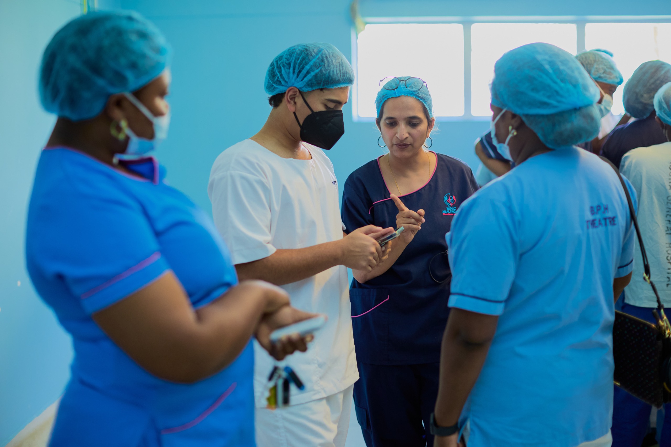 Surgical team collaborating in hospital corridor